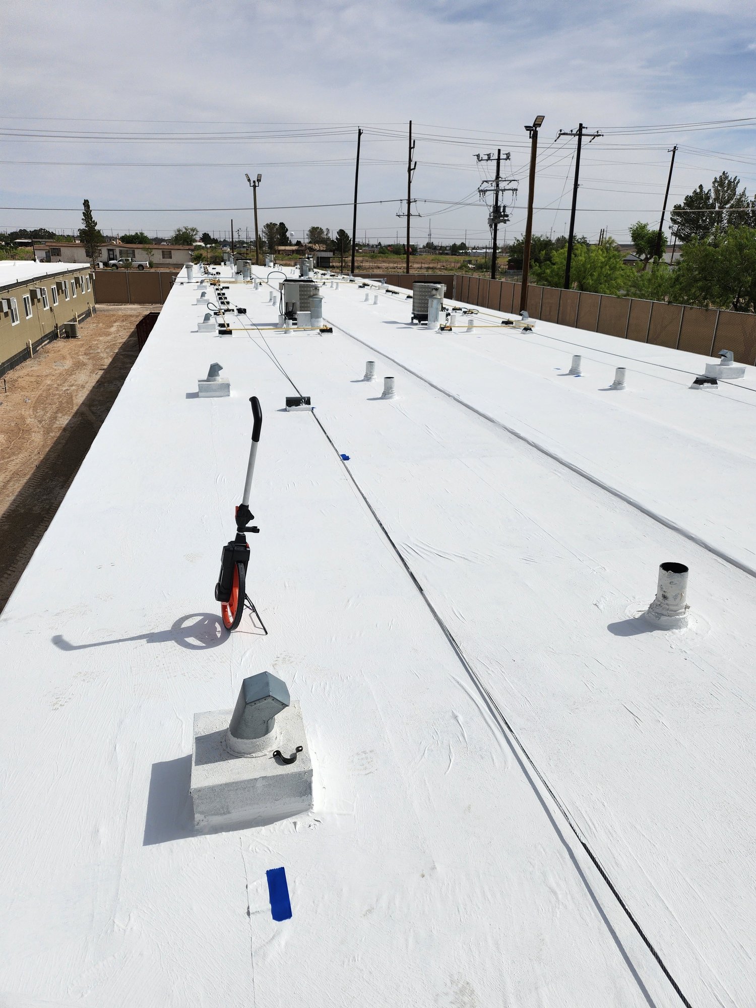 Finished white low-slope coating with penetrations detailed